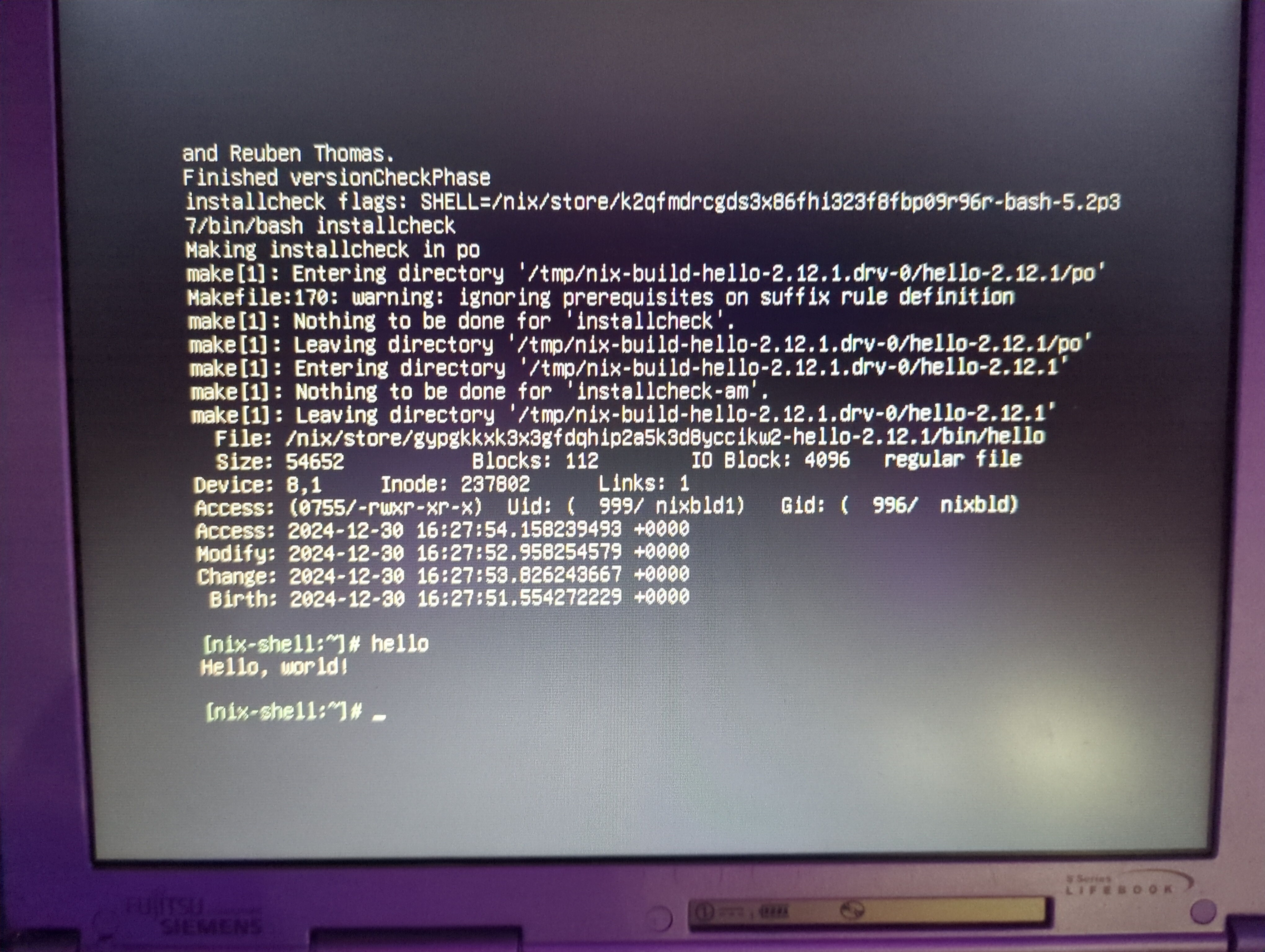 Picture of the laptop screen. The top has the end of the nix build process. Below is:\n[nix-shell:~]# hello\nHello, world!